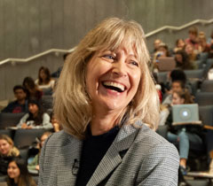 Photo: Professor Anita Oberbauer, smiling, in front of lecture hall full of students