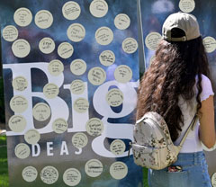 Photo: A woman stands at the Big Ideas idea board, where people contributed their Big Ideas for UC Davis during Give Day-Picnic Day 2019