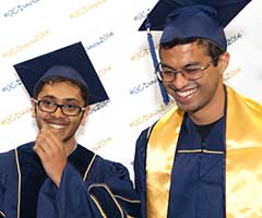 Photo: Soon-to-be-graduates Taj Badail and Pradeep D'Souza, modeling UC Davis' new, blue commencement gowns