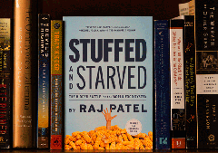 Photo: Campus Community Book Project books on bookshelf, with Stuffed and Starved in the center