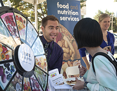 Photo: UCDHS dietetic intern Daniel Andras mans a booth at food and health fair