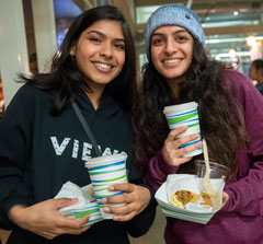 Photo: Two unidentified female students holding their plates at the Moonlight Breakfast