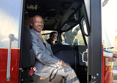 Photo: Chancellor Gary S. May rides in new fire engine, with Kyle Dubs driving