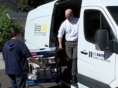 Photo: Professor Lee Martin and a high school student unload equipment from the Beta Lab, a mobile maker lab