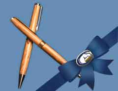 Photo: Olive-wood pens, with blue Aggie ribbon and bow